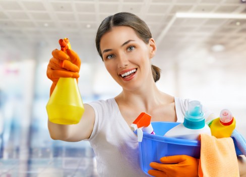 Removing leaves and debris from gutters on a Southkensington home